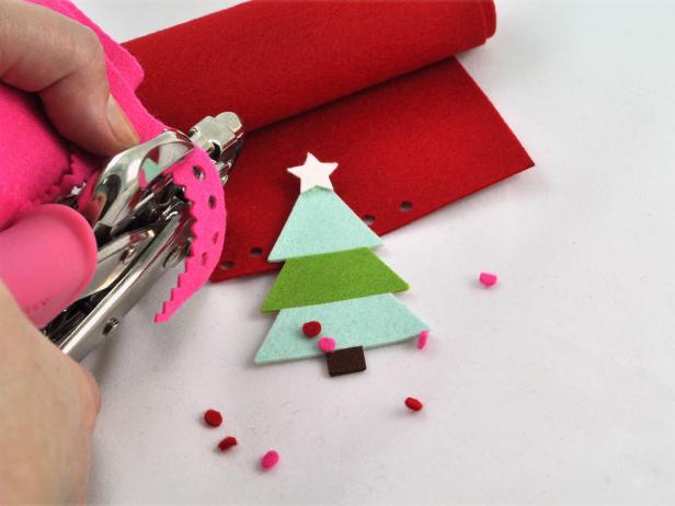 Using a sharp 1/8” hole punch, punch felt dots to create ornaments to coordinate for a felt Christmas tree decoration.