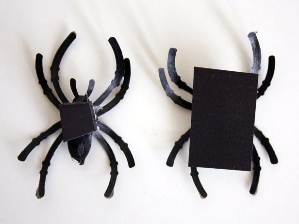 Attach spider to magnetic strip, you may need to tilt it upward and use a lot of hot glue so the magnet will fully stick to the metal surface. You don't want the magnet to bend or ripple at all.