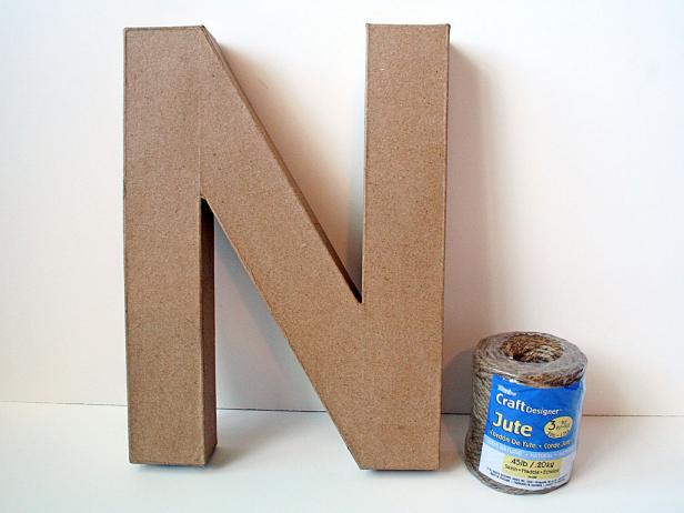 Start your craft with a paper mache letter and roll of twine.