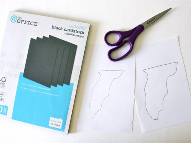 After searching for &quot;bat template&quot; online, trace your template onto the sheet of white paper and cut out a template. (It'll be half of a bat.)