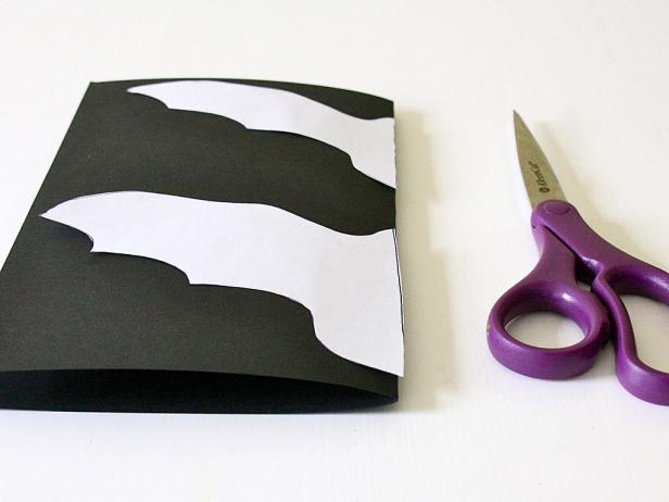 Black paper, white template, and purple scissors