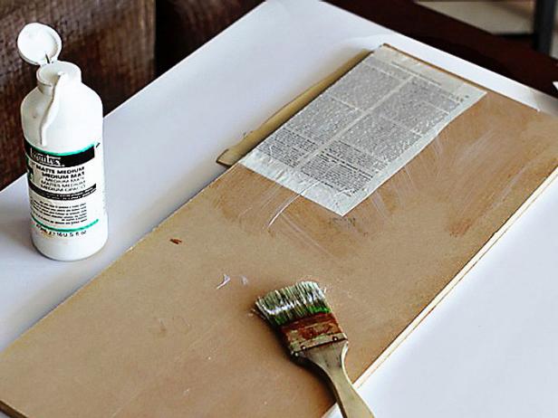 Layer the pages from an old book on an old board and brush each one with a thin layer of Liquitex Matte Medium, which will act as glue.
