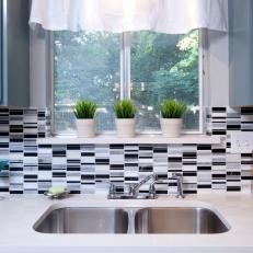 Kitchen With Black-and-White Tile Backplash