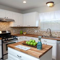 White Kitchen and Island With Butcher Block Countertops