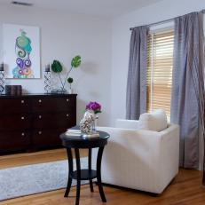 White Sitting Room With Dark Wood Dresser