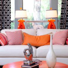 Neutral Contemporary Sofa With Orange Decor and Graphic Curtains