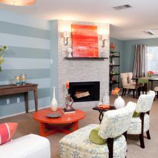 Eclectic Blue and Orange Living Room With Fireplace and Paisley Patterned Chairs 