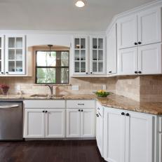 Open Kitchen With Tile Backsplash and White Cabinets