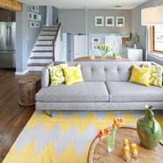 Living Room With Gray Tufted Sofa and Bright Yellow Throw Pillows