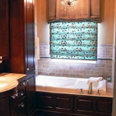 Traditional Bathroom With Rich Wood Accents and Chandelier