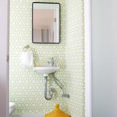 Small Powder Room With Graphic Wallpaper and Wall-Mounted Sink