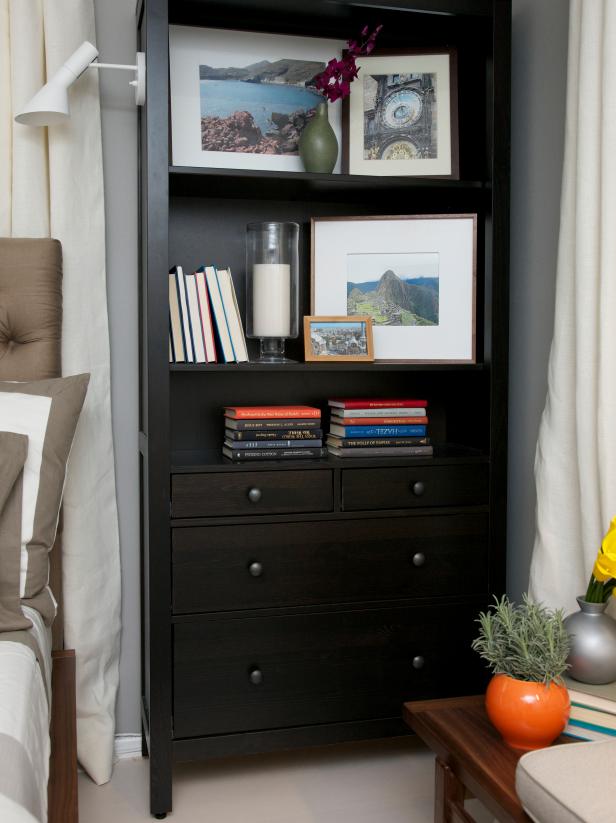 Black Bookcase With Framed Photos Beside Bed