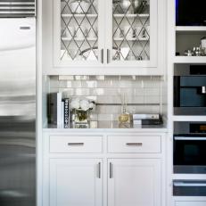 White Kitchen Nook with Glass-Front Cabinets