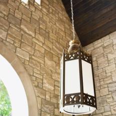 Stone-Clad Outdoor Space With Pendant Lantern