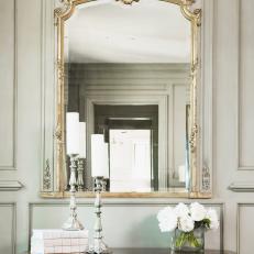 Antique Table and Gilt Mirror in Neutral Hallway