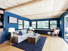 Navy Blue Living Room With Pine Ceilings and Deck Access