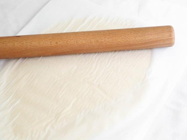 Turn the dough out onto a sheet of wax paper and top with a second sheet. Roll dough into an oblong disc between the papers with a rolling pin.