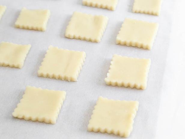 Cut dough into 3-inch squares using a cookie cutter and place on parchment-lined baking sheets.