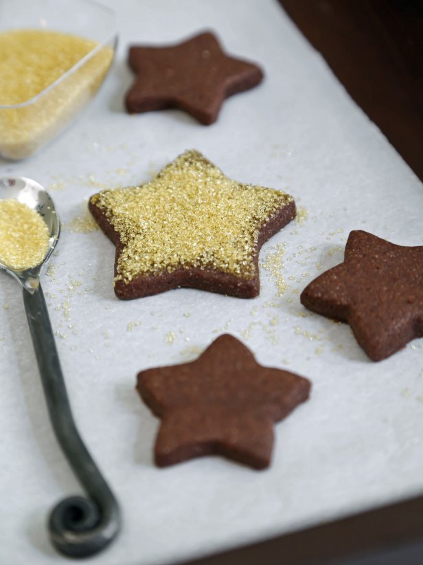 Star shaped chocolate cookies with gold dusting