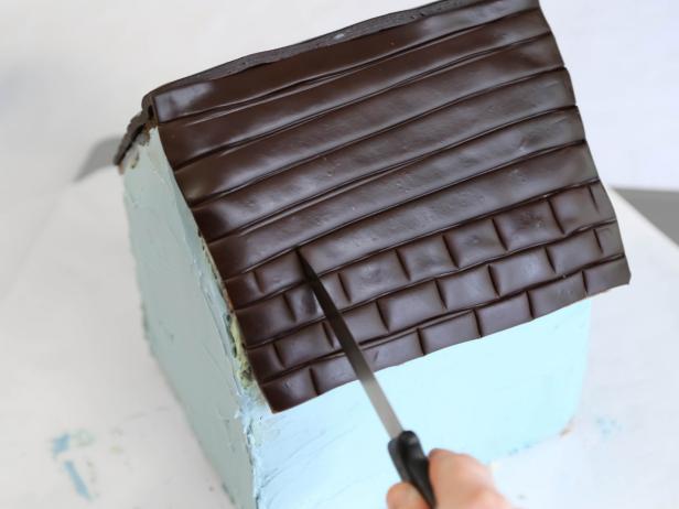 Use the back of a knife to create vertical lines for &quot;shingles&quot; on the chocolate fondant roof.