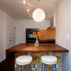 Funky Patterned Breakfast Bar With White Stools