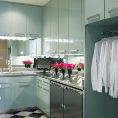 Laundry Room With Lacquered Cabinetry and Mirror Backsplash
