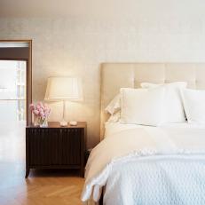 Neutral Bedroom with Textured Bedding and Herringbone Hardwood Floors