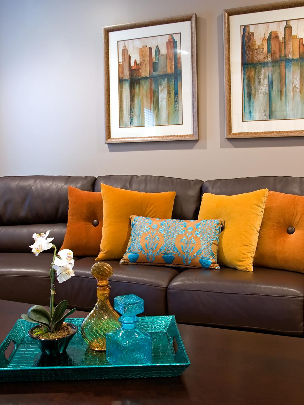 Contemporary Brown Leather Sofa With Orange Throw Pillows | HGTV