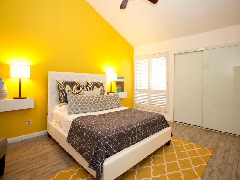 White Bedroom With Yellow Accent Wall & Floating White Nigthstands