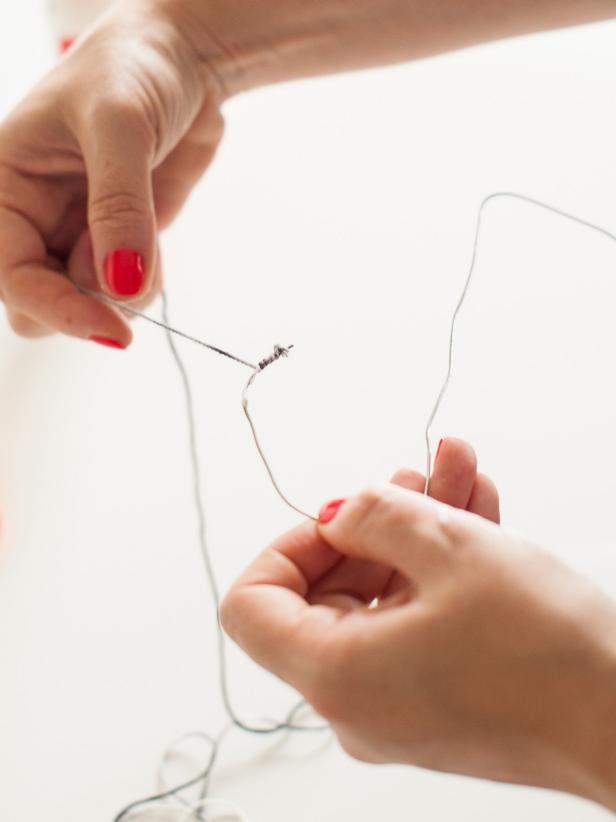Place a line of glue on the first inch of wire then begin wrapping yarn.