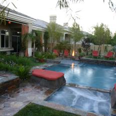 Asian-Inspired Pool With Red Cushions and Fire Pit