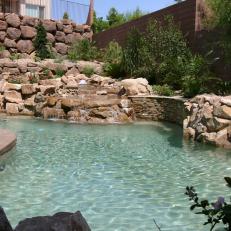 Stone Pool Oasis With a Raised Spa