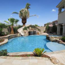 Neutral Tropical Pool with Hidden Grotto & Water Slide