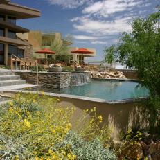 Pool Area With Natural Elements and Waterfall