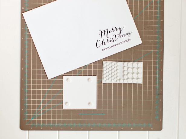 For dimension, add foam dots to the back of a glittered family photo then attach it above the greeting of your printed card template.