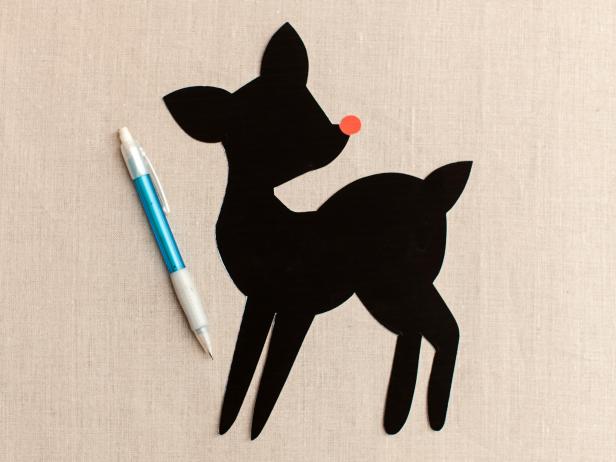 Use scissors to cut out the silhouette then trace around the design onto your pillow's front center using a pencil.