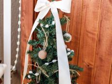Spread the holiday cheer to your front porch with this easy-to-decorate mini Christmas tree. A few handmade touches make it special.