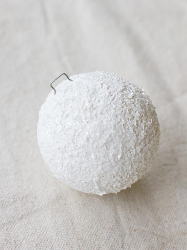 Push a tidy pin into the top of each snowball.