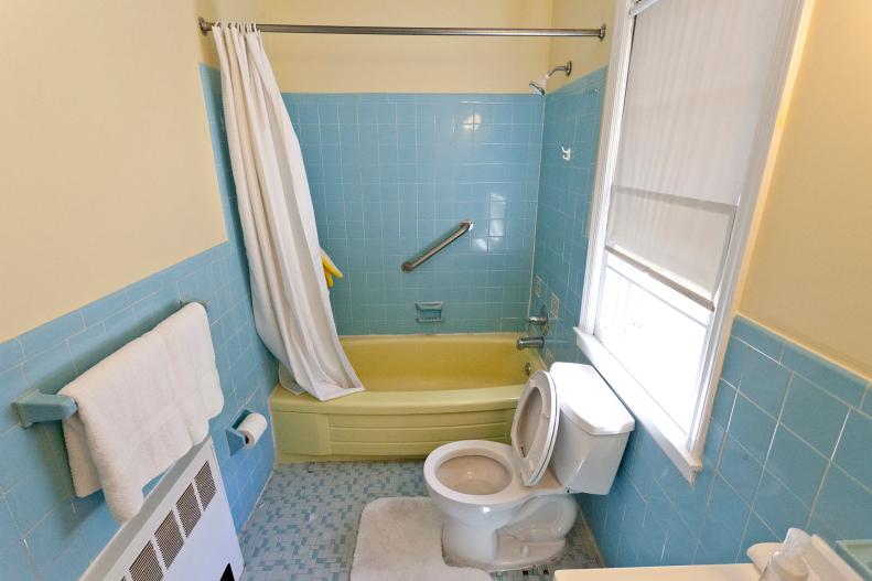 Outdated Light Blue and Yellow Bathroom With Yellow Bathtub
