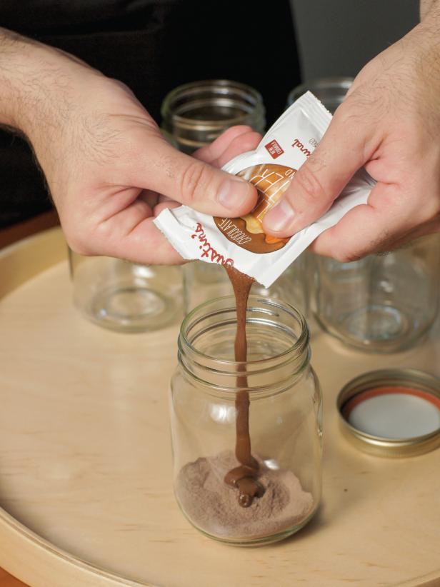 Place cocoa mix in the jar. Add 3/4 of hazelnut spread. Reserve the rest.