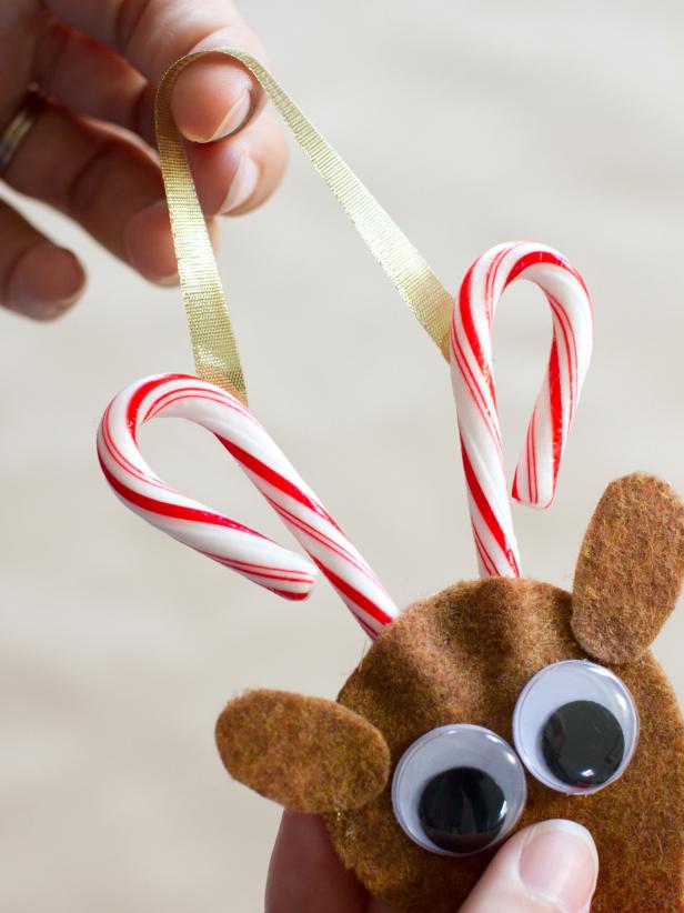 To create the antlers, hot-glue two mini candy canes inside the top of the reindeer's head (Image 1). Hot-glue a 1/4-inch wide piece of ribbon to the back of each candy cane to create a hanger.