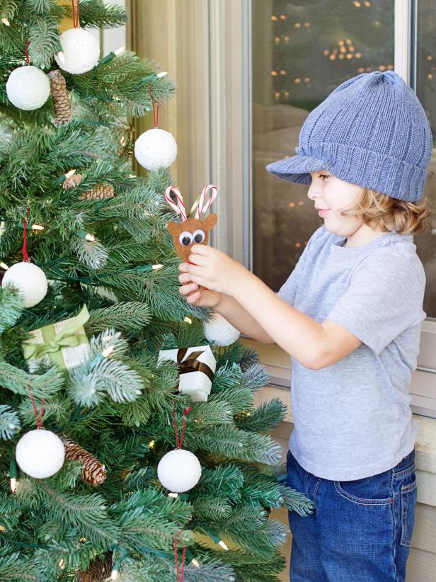 Once glue cools, hang reindeer ornament on the tree.  Tip: These cute critters would also make great gift toppers.
