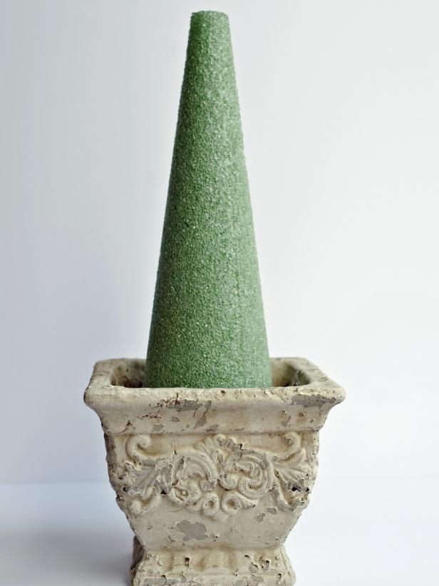 Topiaries can be made in cones, spheres, half spheres and two-tiered forms. Select the desired form shape and size and a complementary pot. A cone form should sit down inside the pot. Tip: It's best to buy a pot slightly larger than the size that might seem appropriate. Once the boxwood sprigs are added, the finished topiary will be much larger than the foam form.