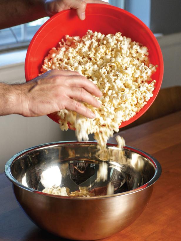 Diving Popcorn into Two Large Bowls