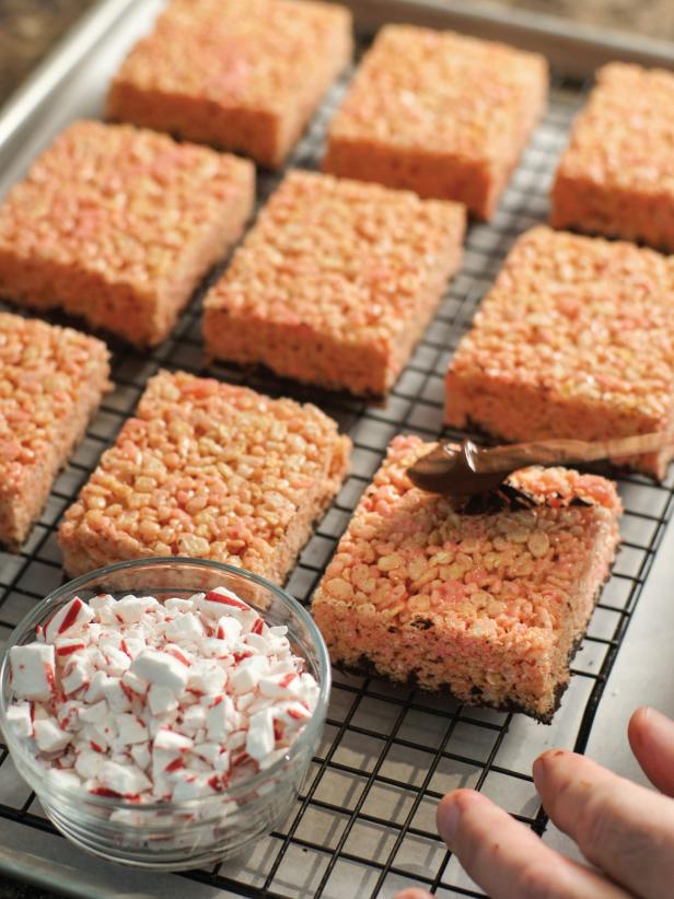 When cooled loosen sides of pan with a knife and turn out onto a cutting board.  Cut into 12 equally sized bars. Melt remaining chocolate chips in heat proof bowl as you did earlier. Spread melted chocolate onto sides and tops of bars and sprinkle with peppermint candy pieces. Allow to cool and harden completely before serving. Store in an airtight container.