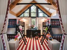 This kid-friendly bunkroom features soaring ceilings, bright colors and whimsical accessories.