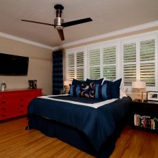 Transitional Bedroom With Blue Accents and Red Dresser