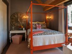 Brown Guest Bedroom With Orange Bed and Oversized Wall Clock