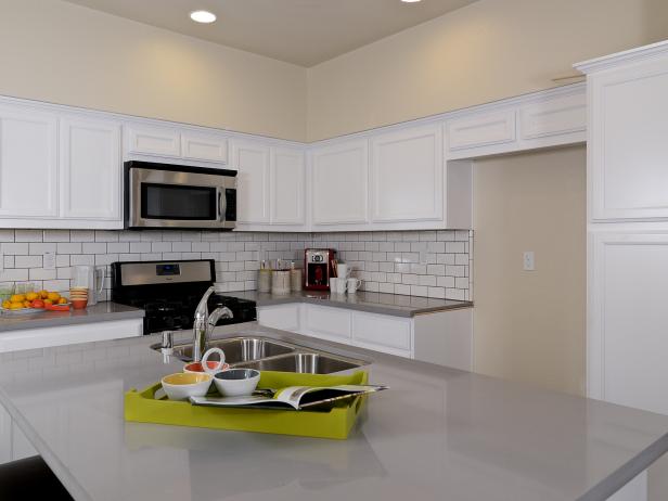 Neutral Kitchen With Gray Concrete Countertop and White Backsplash