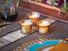 Give plain glass votives a trendy mercury glass makeover with mirror-effect spray paint. The antique-looking votives lend a sparkling glow to a table setting, mantel, coffee table &#8212; or anywhere.